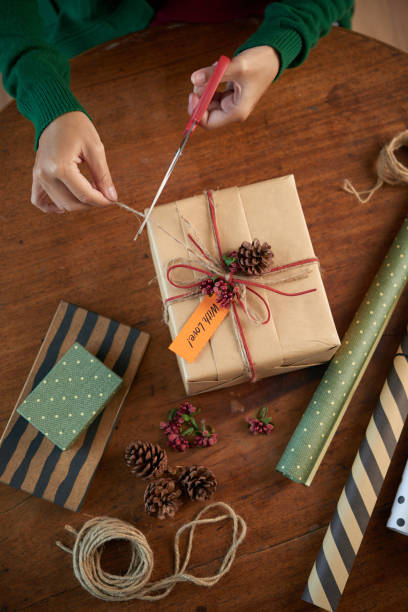 istock Crop person packing Christmas present 1085260424