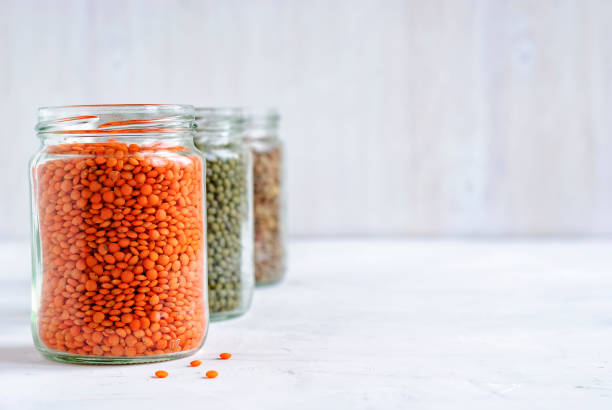 istock Red or orange lentils in a glass storage jar 1085261198