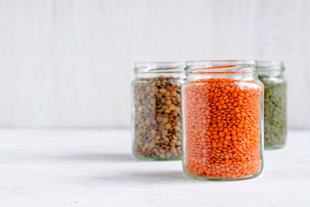 istock Red or orange lentils in a glass storage jar 1085261246