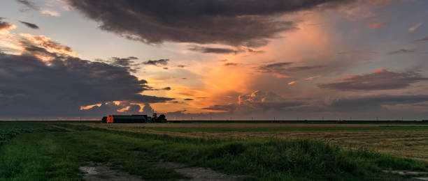 istock Panorama of a barn and stormclouds illuminated by the light of the setting sun 1085265570