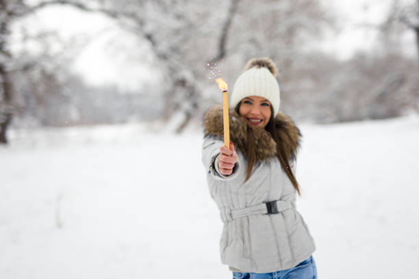 istock Young woman is celebrating with sparkler 1085266060