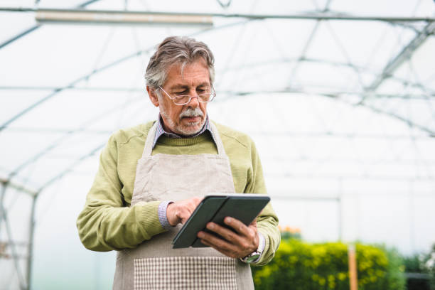 istock Senior man checking the quality of the plants and using a digital tablet 1085272454