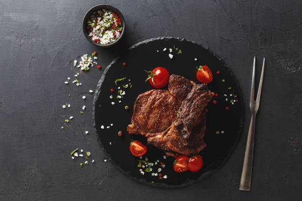 istock Rib eye steak on dark plate with thuja 1085273682