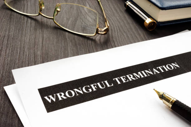 documents about wrongful termination on a wooden desk. - finishing employment issues occupation downsizing imagens e fotografias de stock