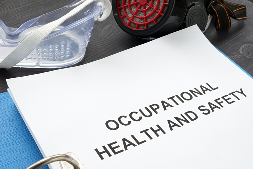 Occupational health and safety ohs act with blue folder.