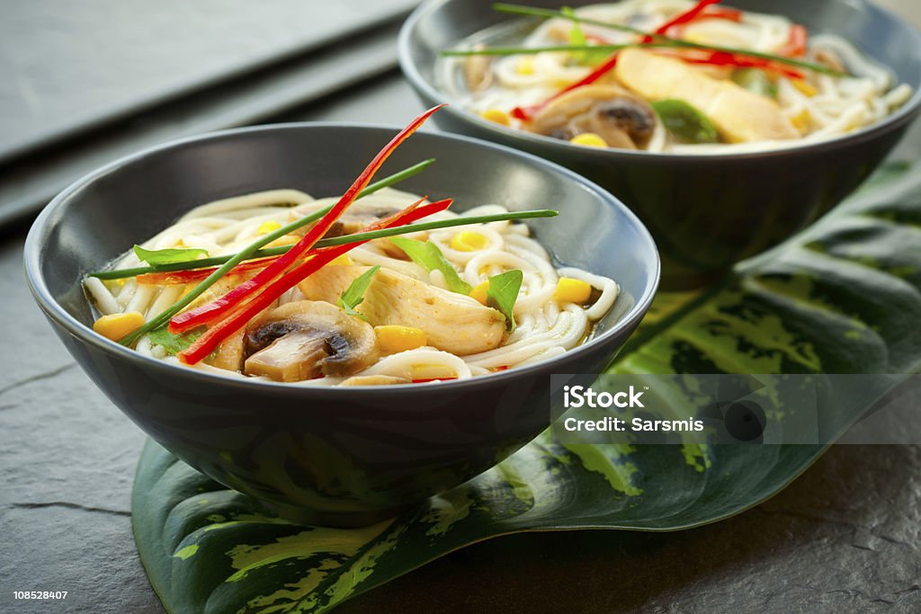 Chicken noodle soup Bowls of Asian noodle soup with chicken,mushrooms, sweetcorn  and chilli Appetizer Stock Photo