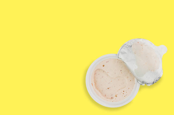 istock Single plastic jar of pate on yellow background with copy space for your text 1085290014