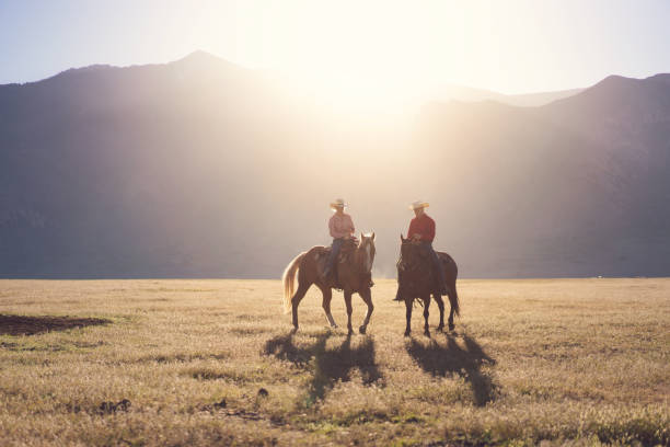 Cowboys Horseback Riding at sunrise