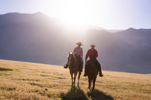 istock Cowboys Horseback Riding at sunrise 1085292420