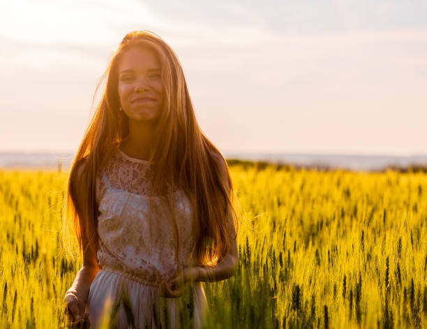 istock Happy girl in wheat field at sunset 1085292784