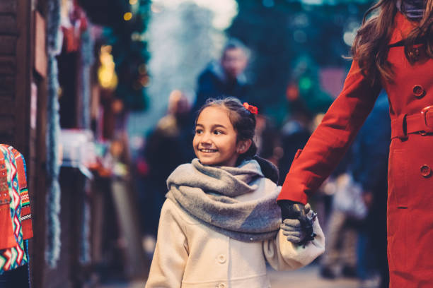 istock Mother with daughter on Christmas shopping 1085294516