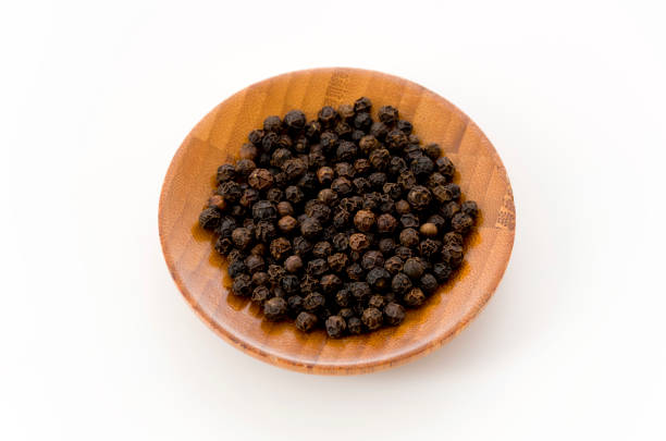 istock black pepper in a wooden dish on white background 1085297912