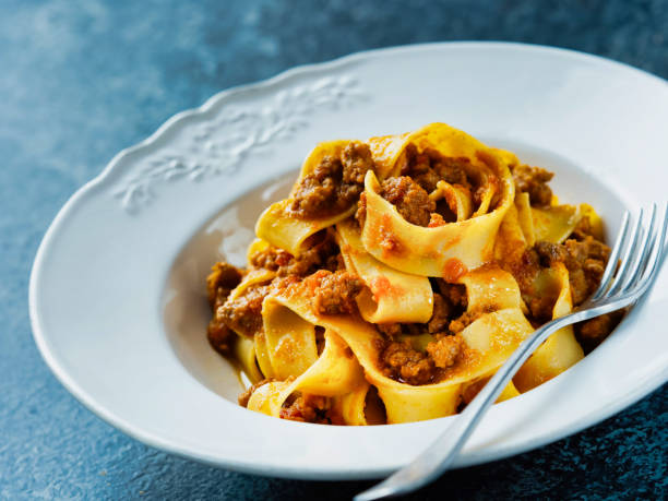 istock rustic italian pappardelle bolognese pasta in meat sauce 1085297968