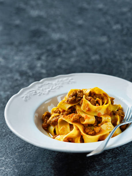 istock rustic italian pappardelle bolognese pasta in meat sauce 1085297972