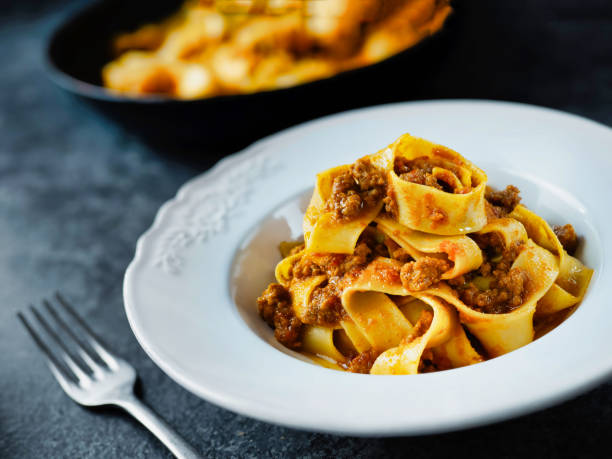 istock rustic italian pappardelle bolognese pasta in meat sauce 1085298028