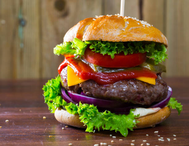 istock Hamburger with beef and ketchup, tomato, cheese, cucumber and lettuce 1085299510