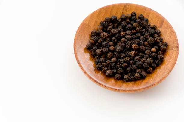 istock black pepper in a wooden dish on white background 1085300598