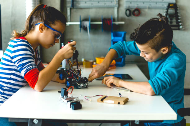 istock Brother and sister working on school project together 1085309696