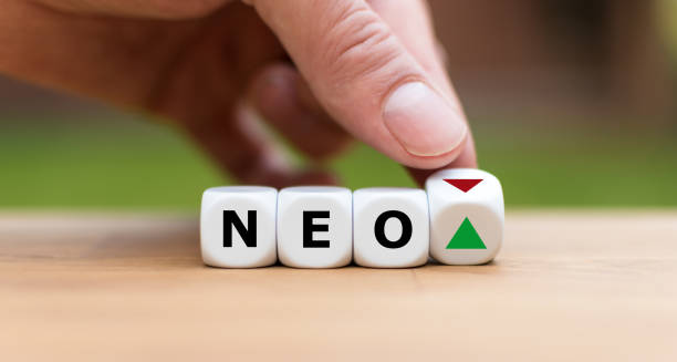 istock Hand is turning a dice and changes the direction of an arrow symbolizing that the value of the crypto currency NEO is going up (or vice versa) 1085310582