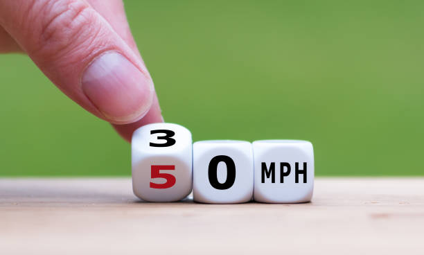 istock Hand turns a cube and changes the speed limit from 50 km/h to 30 km/h 1085310666