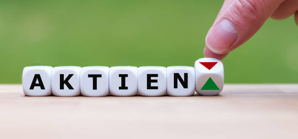 istock Hand is turning a dice and changes the direction of an arrow symbolizing that the value of stocks (