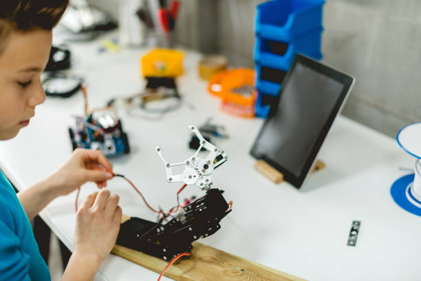 istock Teenage boy Working with robotics 1085312692