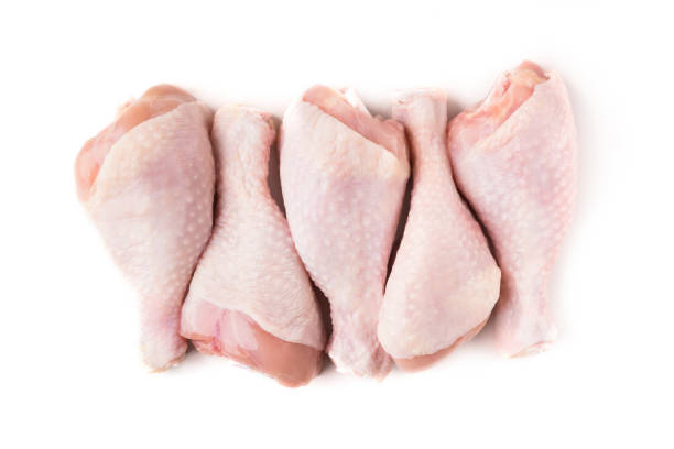 Uncooked chicken legs on white background Uncooked chicken legs in row isolated on white background, top view raw food stock pictures, royalty-free photos & images