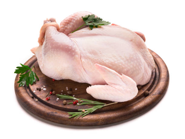 istock Fresh chicken with spices on wooden plate 1085313276