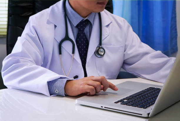 istock Midsection Of Doctor Using Laptop On Table 1085313834