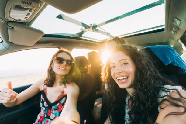 istock Carefree girlfriends enjoying car trip 1085317100