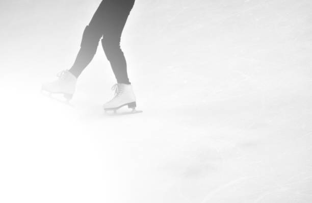 istock Girl with figure skate on interior  ice rink 1085317610