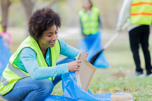 istock Woman picks up garbage during community cleanup event 1085319134