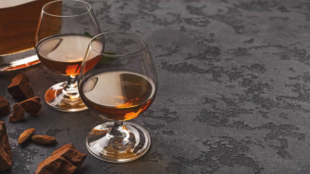 istock Two glasses with cognac, whiskey stones and almonds 1085322450
