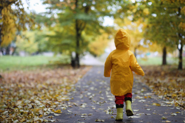 istock A child in a raincoat for a walk outside 1085324984
