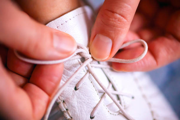 istock Woman hands tying shoelaces. 1085325422