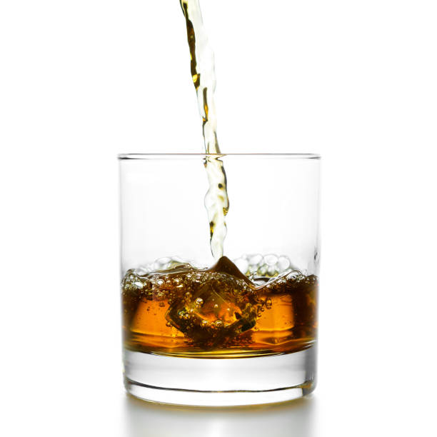 istock Golden whiskey pouring into lowball 1085325534