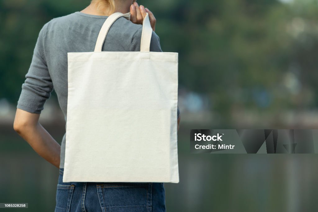 woman carry bag on nature background in save earth concept or say no plastic bag. Bag Stock Photo