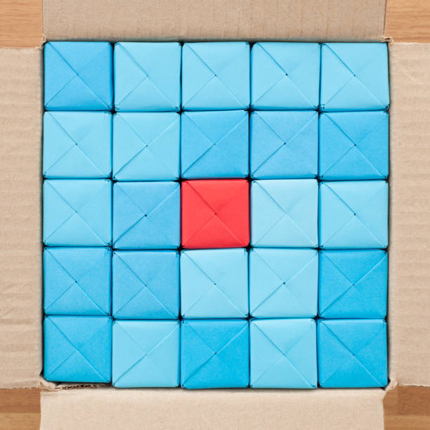 istock Boxed blue cubes with red one in the middle 1085328596