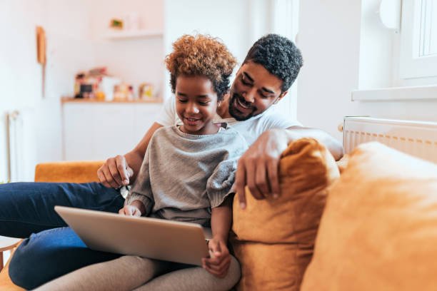 istock Father and daughter using laptop together at home. 1085333732