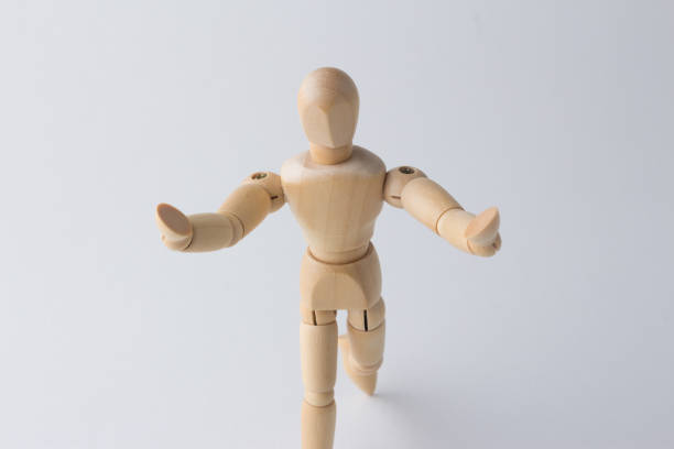 istock wooden dummy with rasing the arms 1085334392