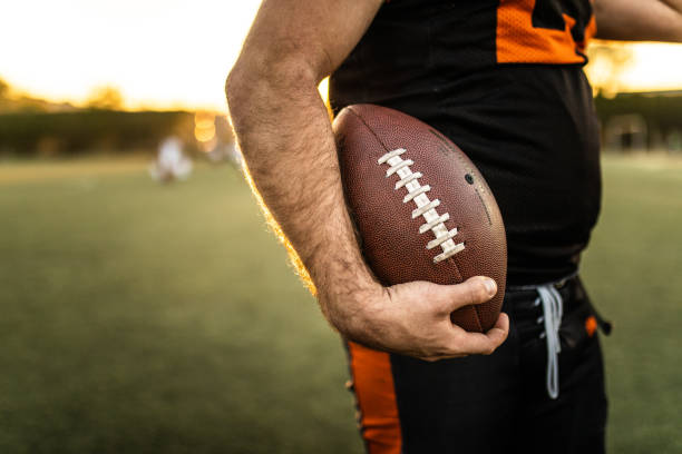istock Football Player Holding Ball 1085339148