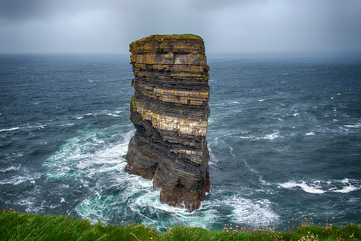 Stormy clouds and a rough sea at the cliffs of Downpatrick Head in the county of Mayo, Ireland.