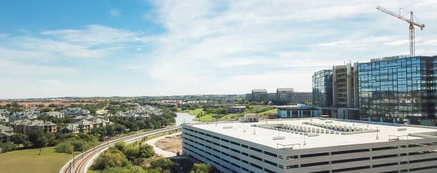 istock Panoramic aerial view building under construction near rail track with working crane Dallas, Texas 1085339612