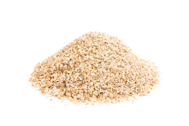 Heap of oat bran isolated on white background Heap of oat bran isolated on white background bran flakes stock pictures, royalty-free photos & images