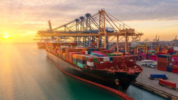 istock Container ship in export and import business logistics and transportation. Cargo and container box shipping to harbor by crane. Water transport International. Aerial view and top view. 1085342622