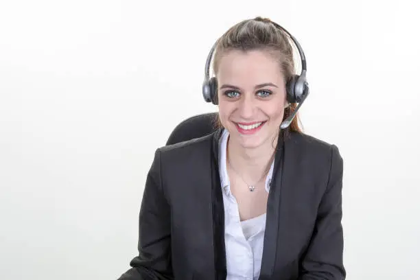 Beautiful young call-center assistant smiling , isolated