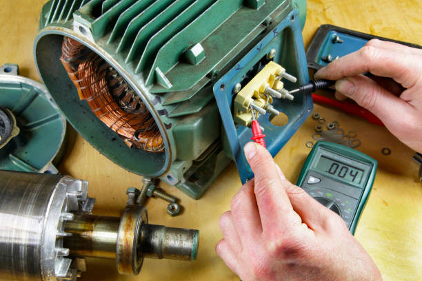Induction motor testing An engineer using a multi meter to check phase continuity induction motor pictures stock pictures, royalty-free photos & images