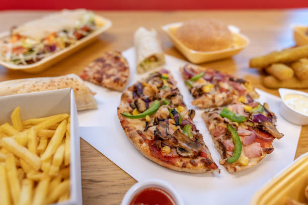istock Pizza slices and other fast food 1085344460