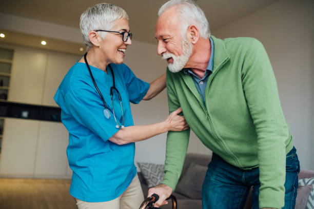 istock Happy nurse helping man walk 1085347570