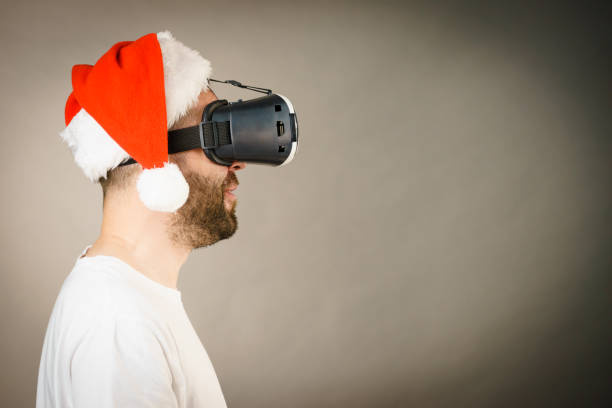 istock Man in virtual reality goggles and santa hat 1085347746